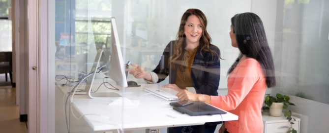 2 women sitting at table